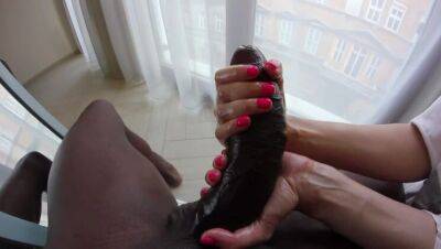 A petite blonde plays with the foreskin of a huge black cock. on freefilmz.com