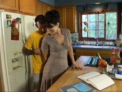 Lusty brunette milf in glasses seduced man next door on her kitchen counter on freefilmz.com