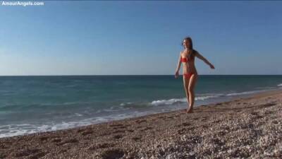 Beautiful honey in a crimson swimsuit got bare on the beach, while no one was seeing her on freefilmz.com