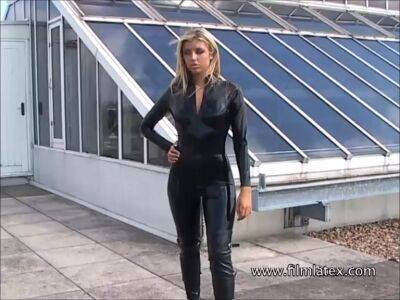 Blonde latex-babes outdoor knee boots and high heels of fetish girl in tight full body rubber outfit with softcore glamour model Karina outside on the roof on freefilmz.com