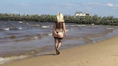 Pretty Woman In A Nylon Bodysuit On The Beach on freefilmz.com