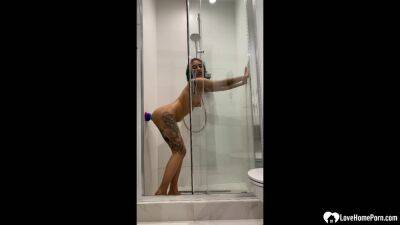 Tattooed teen gril fucking her sex toy in the shower on freefilmz.com