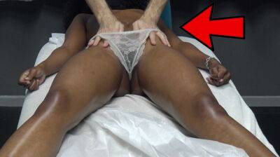 Masseur makes horny black milf massage the customer by pulling the lace underwear on her oiled pussy lips on freefilmz.com