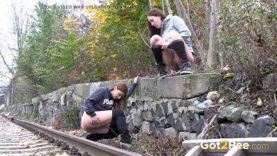 Watch these kinky girls get soaked in pee while getting frisky on the railway on freefilmz.com