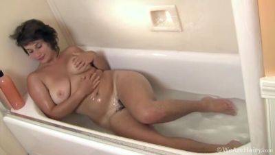 Big-titted brunette, Sayge, indulges in a steamy shower session and soaps up on freefilmz.com