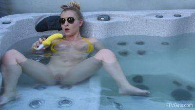 Sweet blonde inserts big dildo in her shaved pussy while in the pool on freefilmz.com